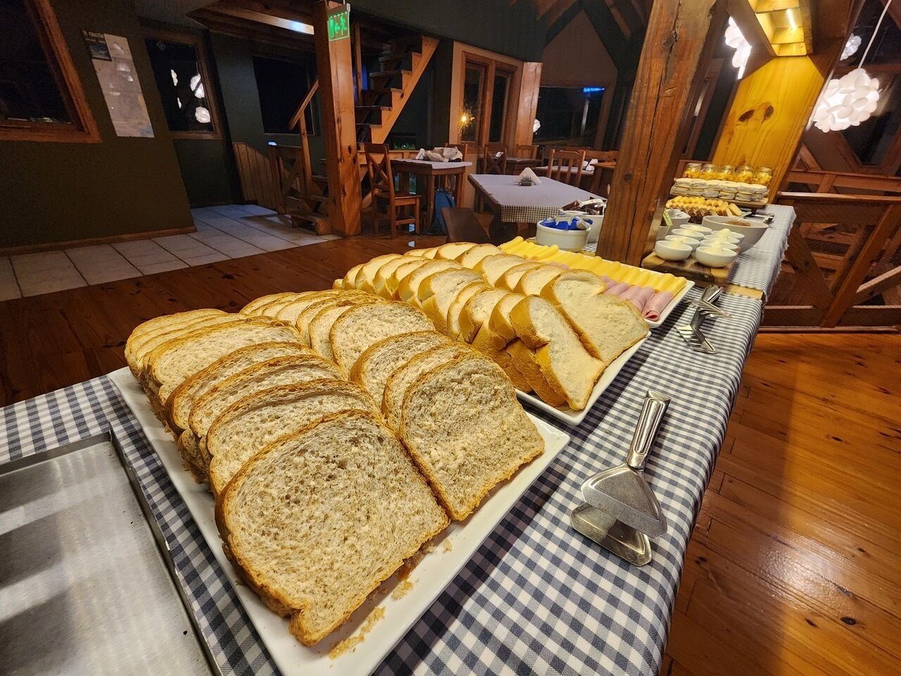 Una mesa de buffet con diferentes tipos de pan y otros alimentos.