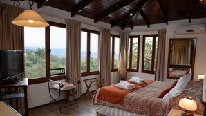 A bedroom with a bed, a television, a desk, and a chair. - Hotel Selva Montana (Villa San Lorenzo)