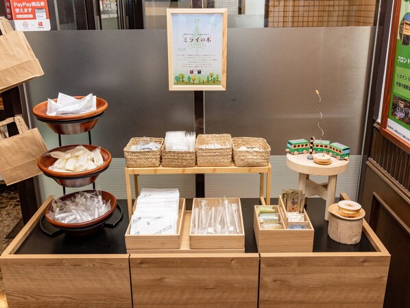 A buffet setup with various food items and utensils.