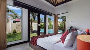 Un dormitorio amplio con una cama grande, vistas a una piscina y un balcón.