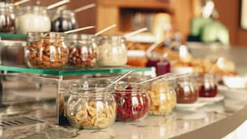 A buffet with various food items in jars, including nuts and dried fruits.