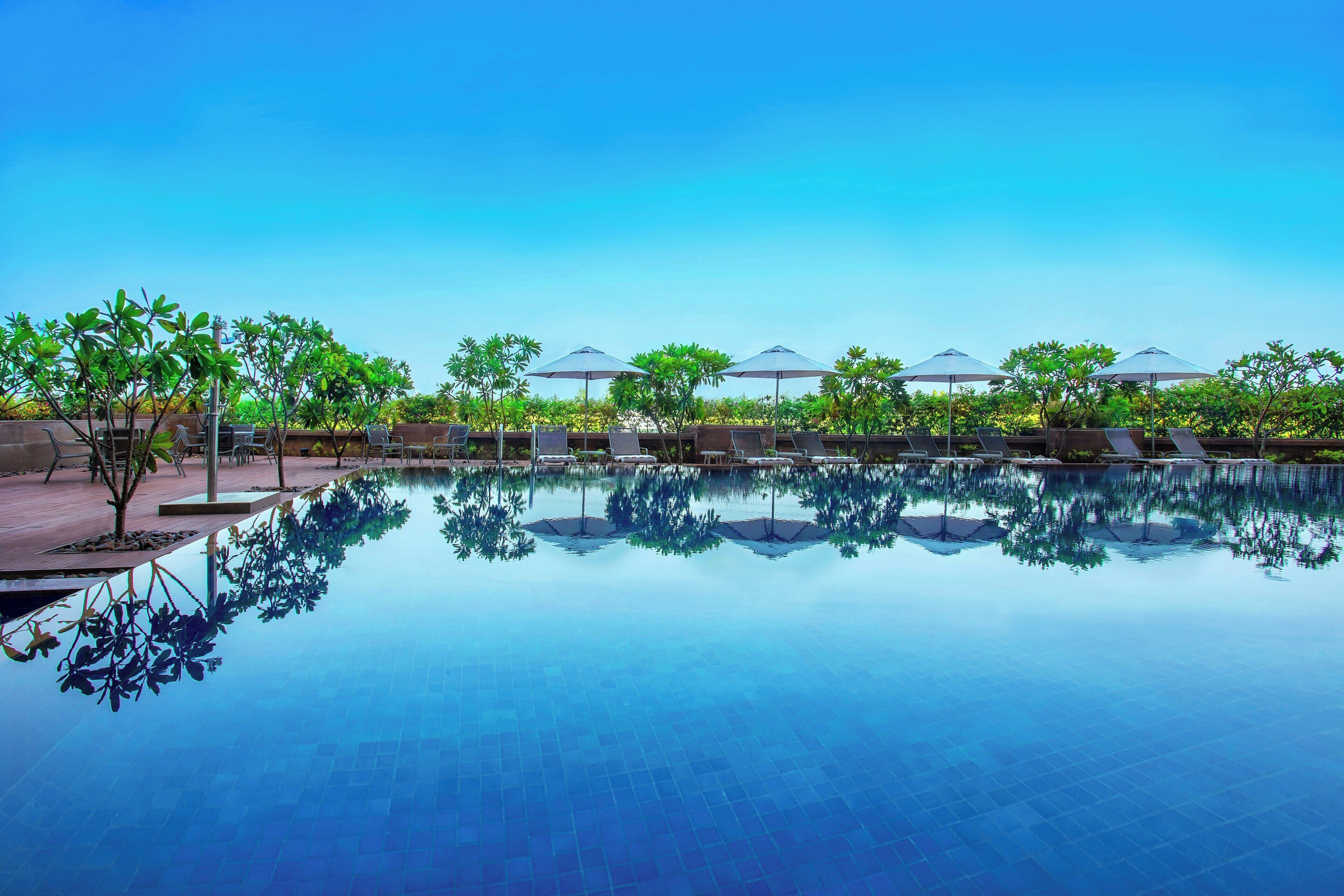 Outdoor pool, open 7:00 AM to 7:00 PM, pool umbrellas, sun loungers