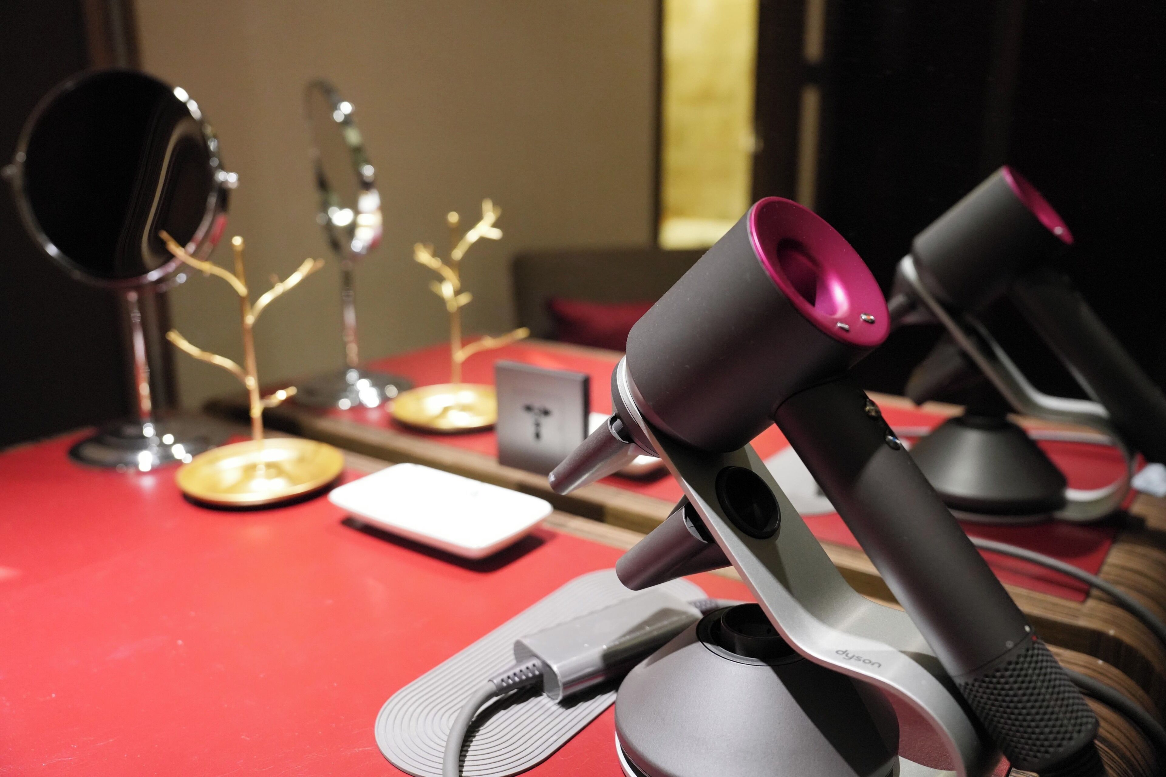 A desk with a microphone, a small white device, and decorative items.