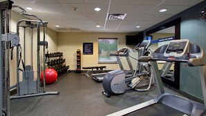 A gym with treadmills, a stationary bike, and a weight machine.