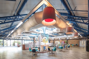 A spacious indoor area with high ceilings, exposed beams, and a modern industrial design. - Holiday Inn Express Rotherham North by IHG (Rotherham)