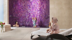 A spa area with a mosaic wall, a massage table, and a towel stack. - NG Afyon (Afyonkarahisar)