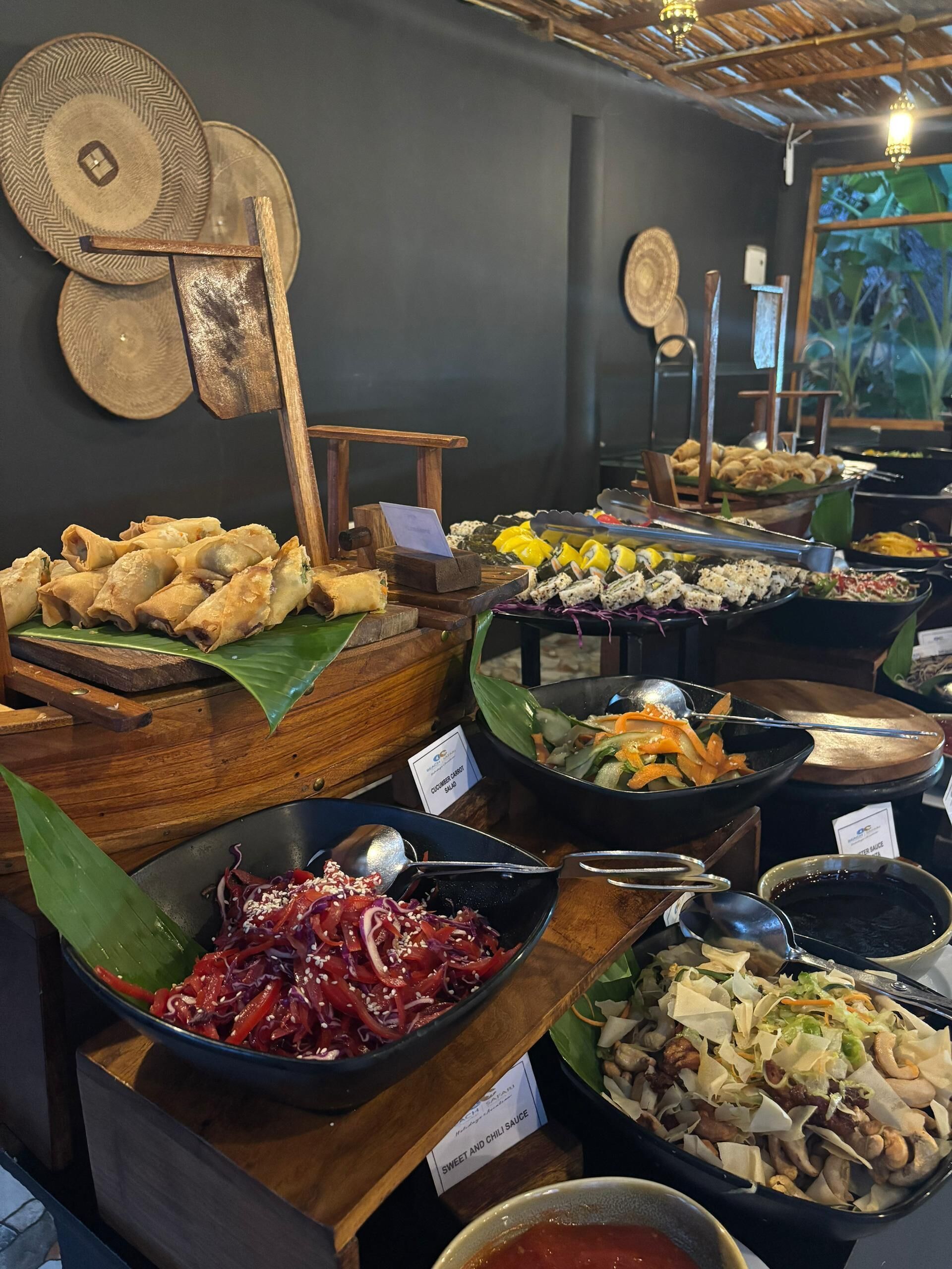 A buffet with various dishes, including fried items, salads, and sauces.