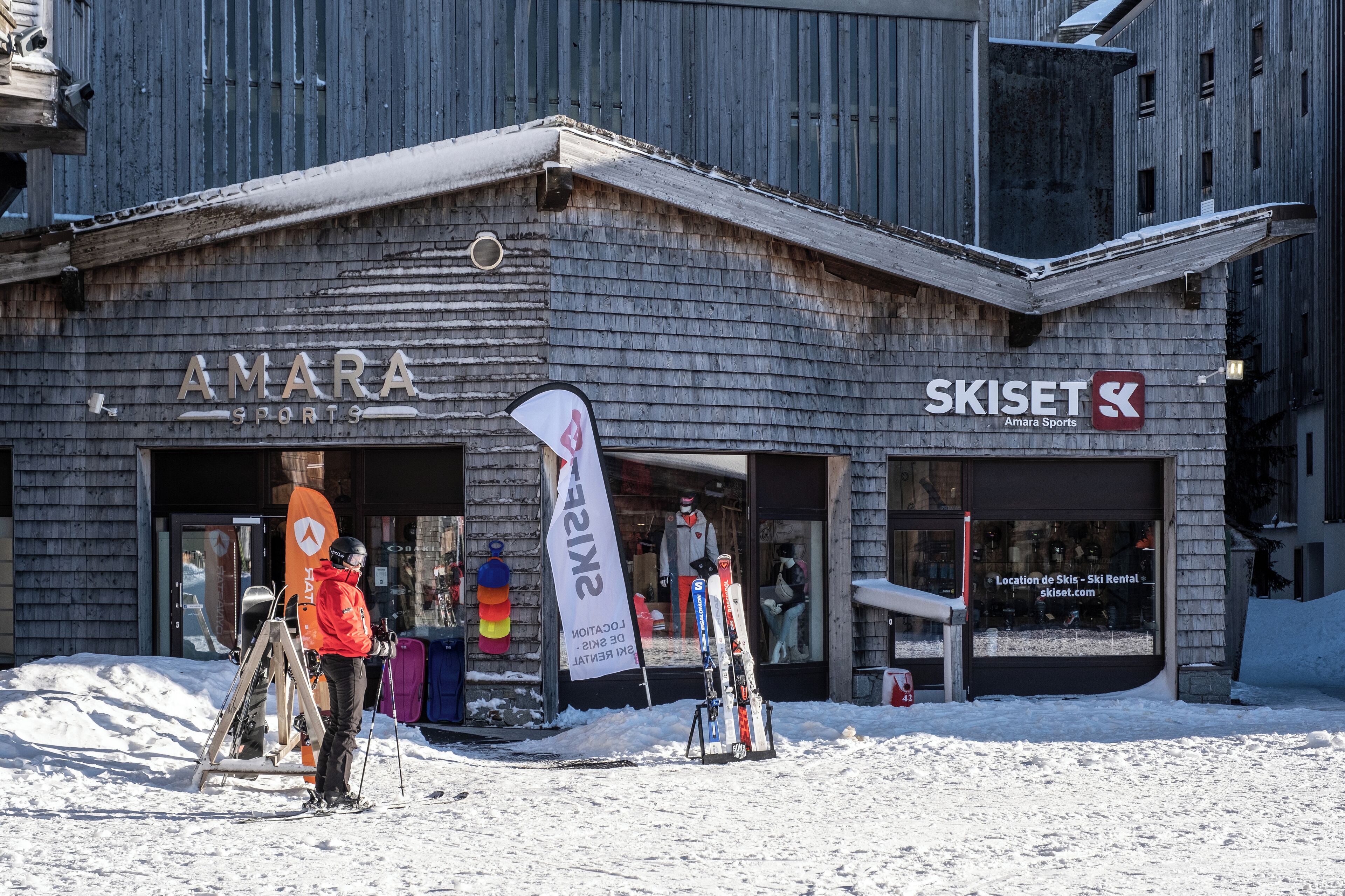A building with signage for Amara Sports and Skiset, featuring a ski rental shop.
