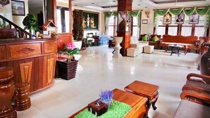 A spacious lobby with a reception desk, seating area, and decorative elements like plants and artwork. - Siem Reap Riverside Hotel (Siem Reap)