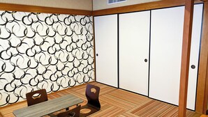 A traditional Japanese room with tatami flooring, a low table, and a sliding door. - HOTEL LiVEMAX Iyo Mishima (Shikokuchuo)