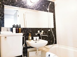 Combined shower/tub, free toiletries, hair dryer, slippers