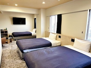 A hotel room with two beds, a flat-screen TV, a desk, and a window with curtains. - HOTEL LiVEMAX Iyo Mishima (Shikokuchuo)
