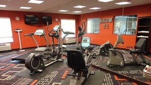 A gym with treadmills, elliptical machines, and stationary bikes.