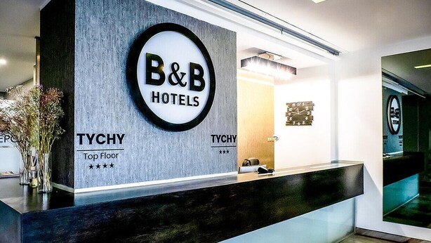 A reception desk at B&B Hotels with a sign for the Tychy Top Floor. -  B&B HOTEL Tychy (Tychy)