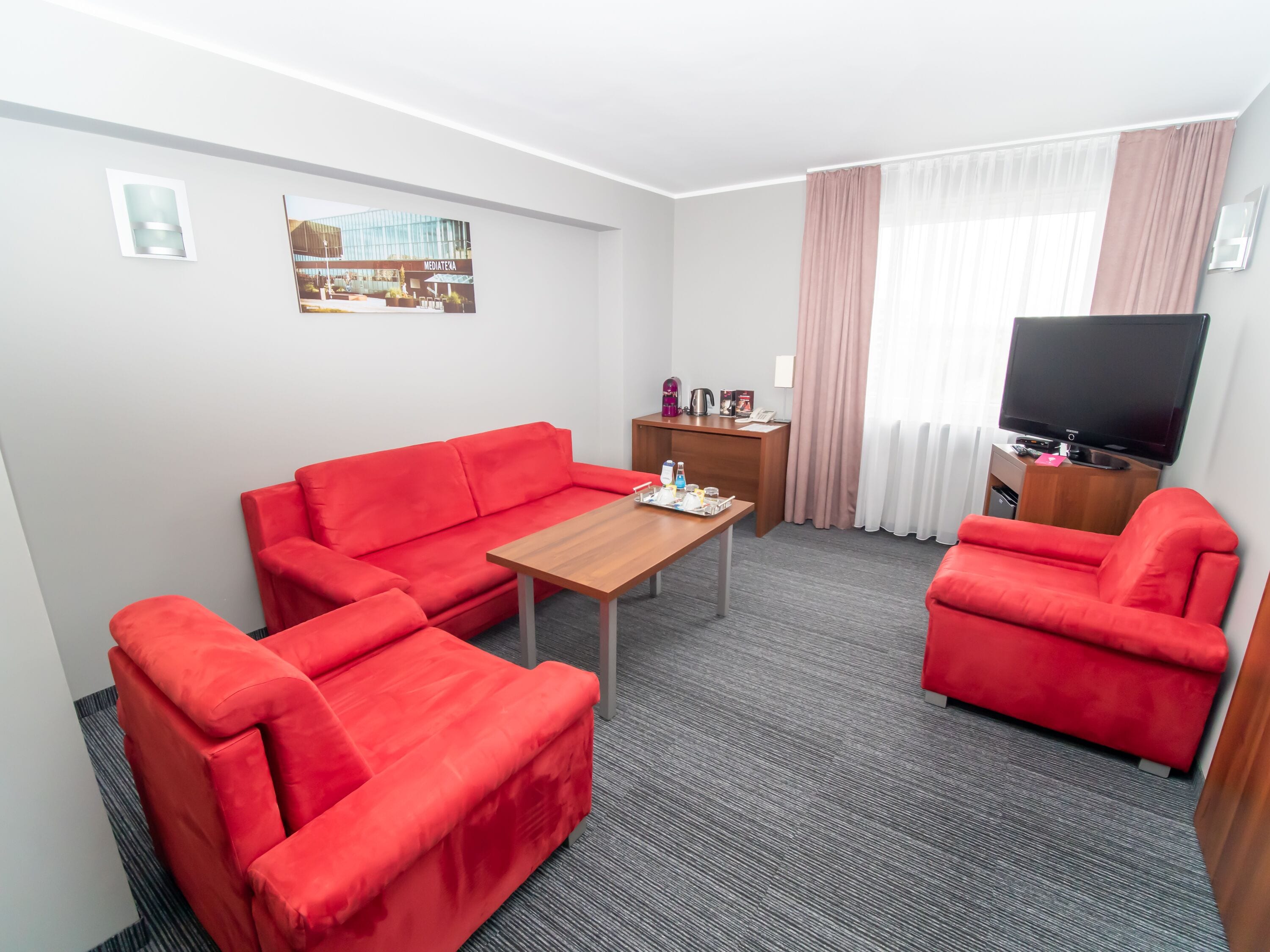standard suite, 1 king bed with sofa bed, city view | living area | flat-screen tv