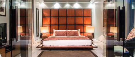 A modern bedroom with a large bed, two bedside tables, and a ceiling with a wooden design.