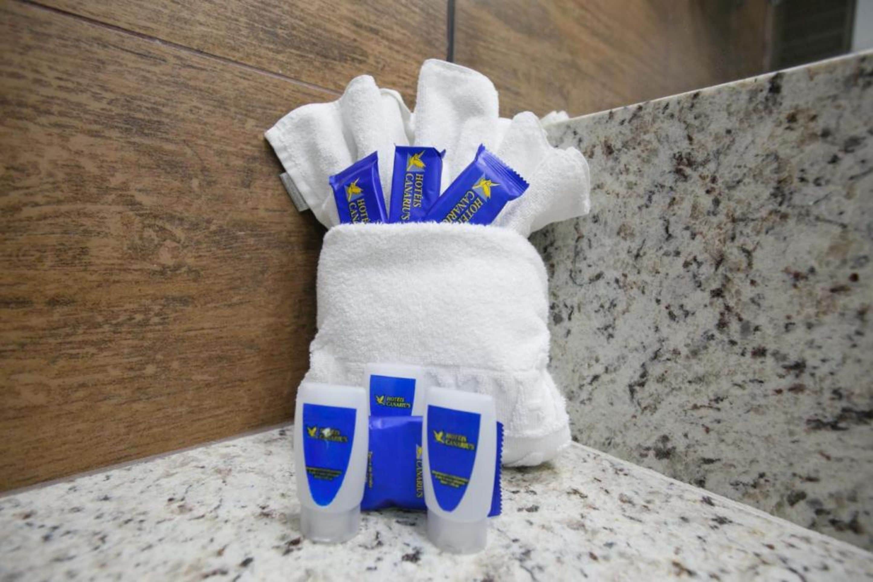 A towel with toiletries on a bathroom counter.