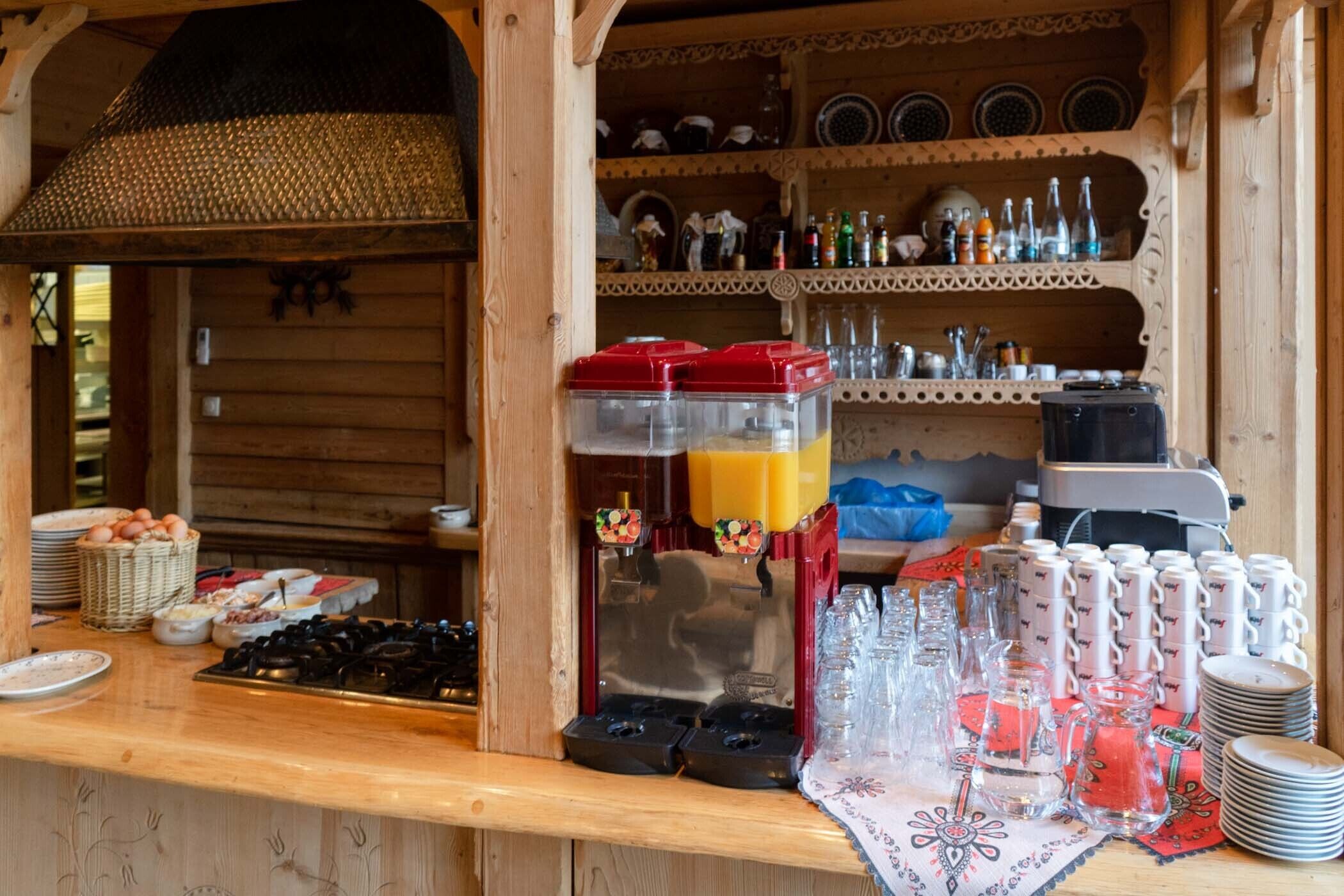 Un aparador amb aliments, un dispensador de suc i una màquina de cafè.