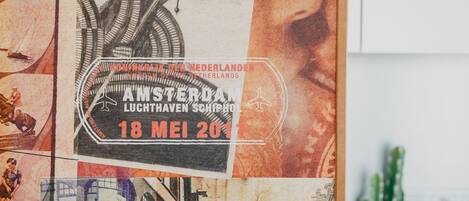 A wall with a vintage poster featuring a train and a woman's face.