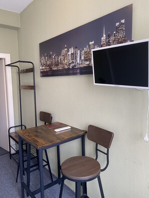 Desk, laptop workspace, blackout curtains, iron/ironing board