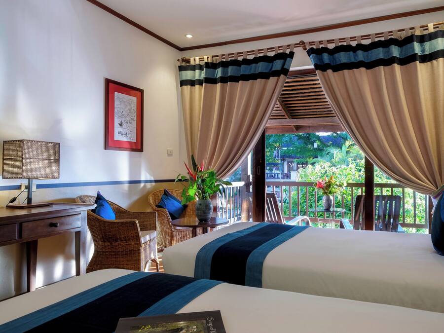 Deluxe Room, 2 Twin Beds, Partial Mountain View | Minibar, in-room safe, individually decorated, desk