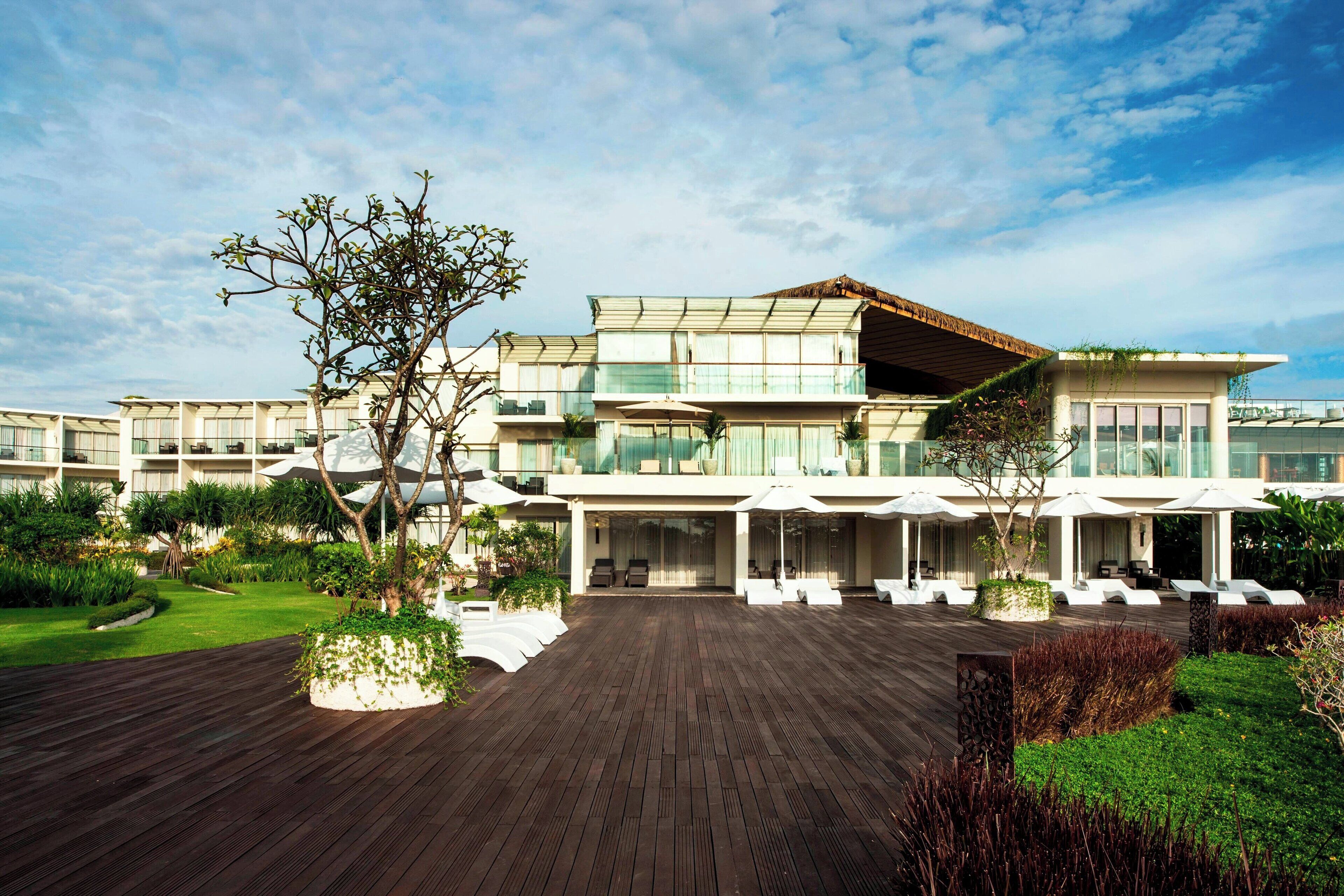 A modern hotel with a spacious outdoor area, multiple levels, and a variety of seating options.