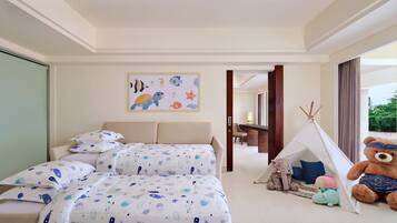 A hotel room with a bed, a teddy bear, a tent, and a wall with a marine-themed painting.