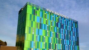 A modern hotel building with a checkered facade and a prominent website address on the top. - Idea Hotel Plus Savona (Savona)
