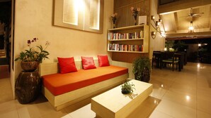 Una sala de estar moderna con sofá, estanterías y comedor.