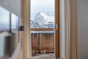 A corridor leading to a balcony with a view of a snow-covered mountain. - Hotel Hochsölden (Soelden)