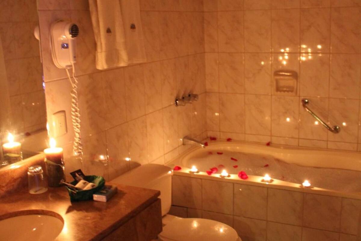 separate bathtub and shower, hair dryer, towels, soap