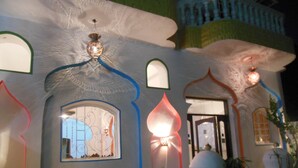 A building with unique architectural features including arched windows and decorative lighting. - Cleopatra Hotel Luxor (Luxor)