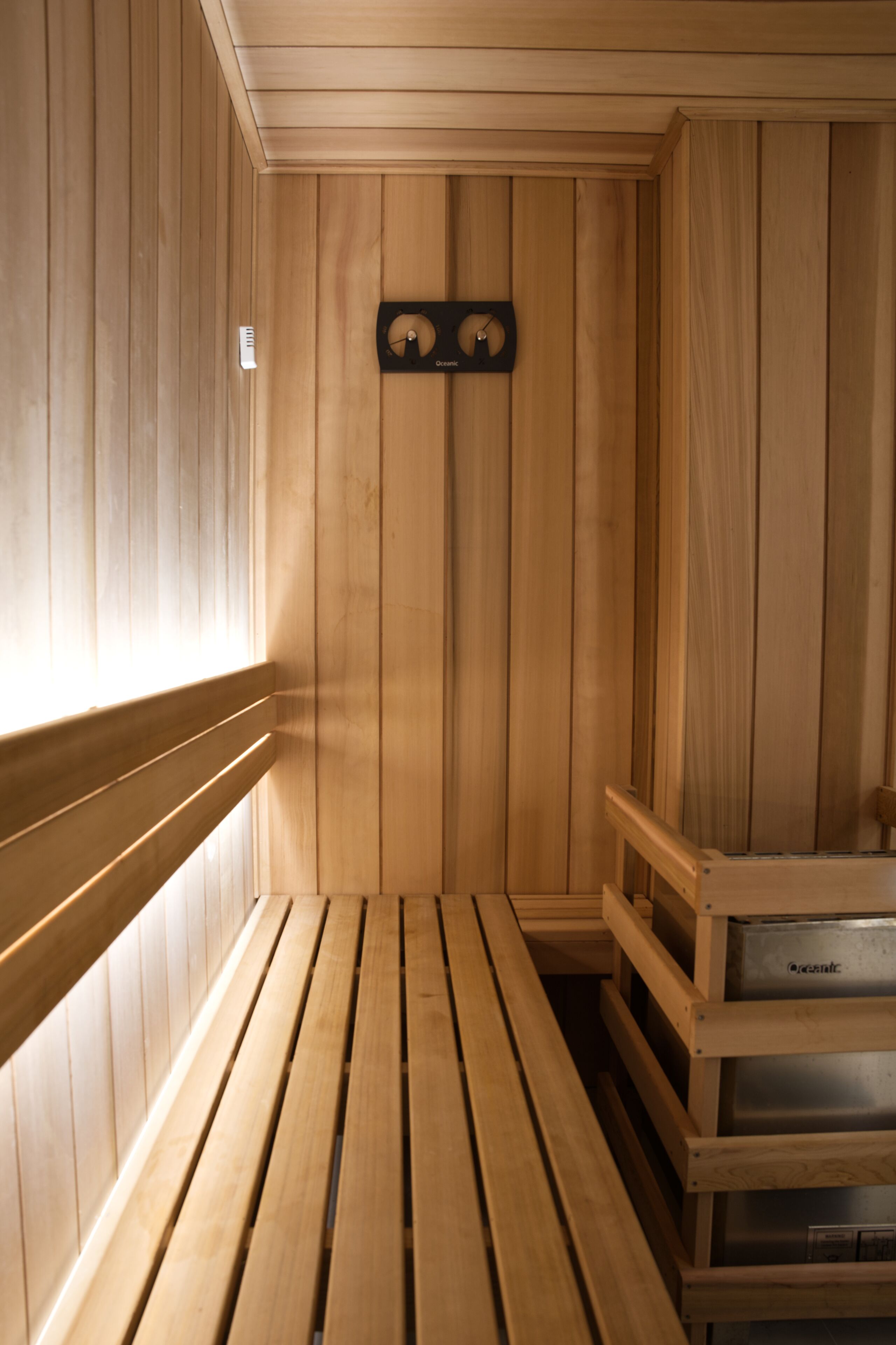A sauna room with wooden walls and benches.