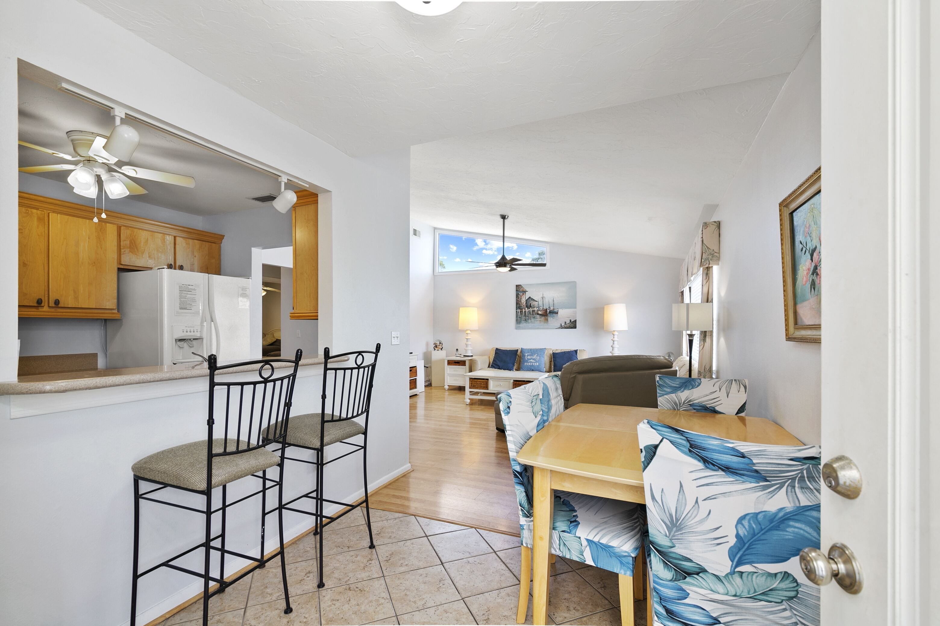 A compact living space with a kitchenette, dining area, and a living room.