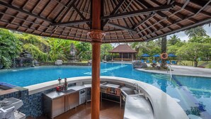 A pool area with a bar, a covered seating area, and a view of the pool. - Bhuwana Ubud Hotel and Farm (Ubud)