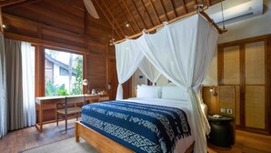 A wooden room with a bed, desk, and window. - Bhuwana Ubud Hotel and Farm (Ubud)