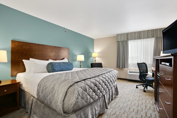 Premium bedding, desk, laptop workspace, blackout drapes