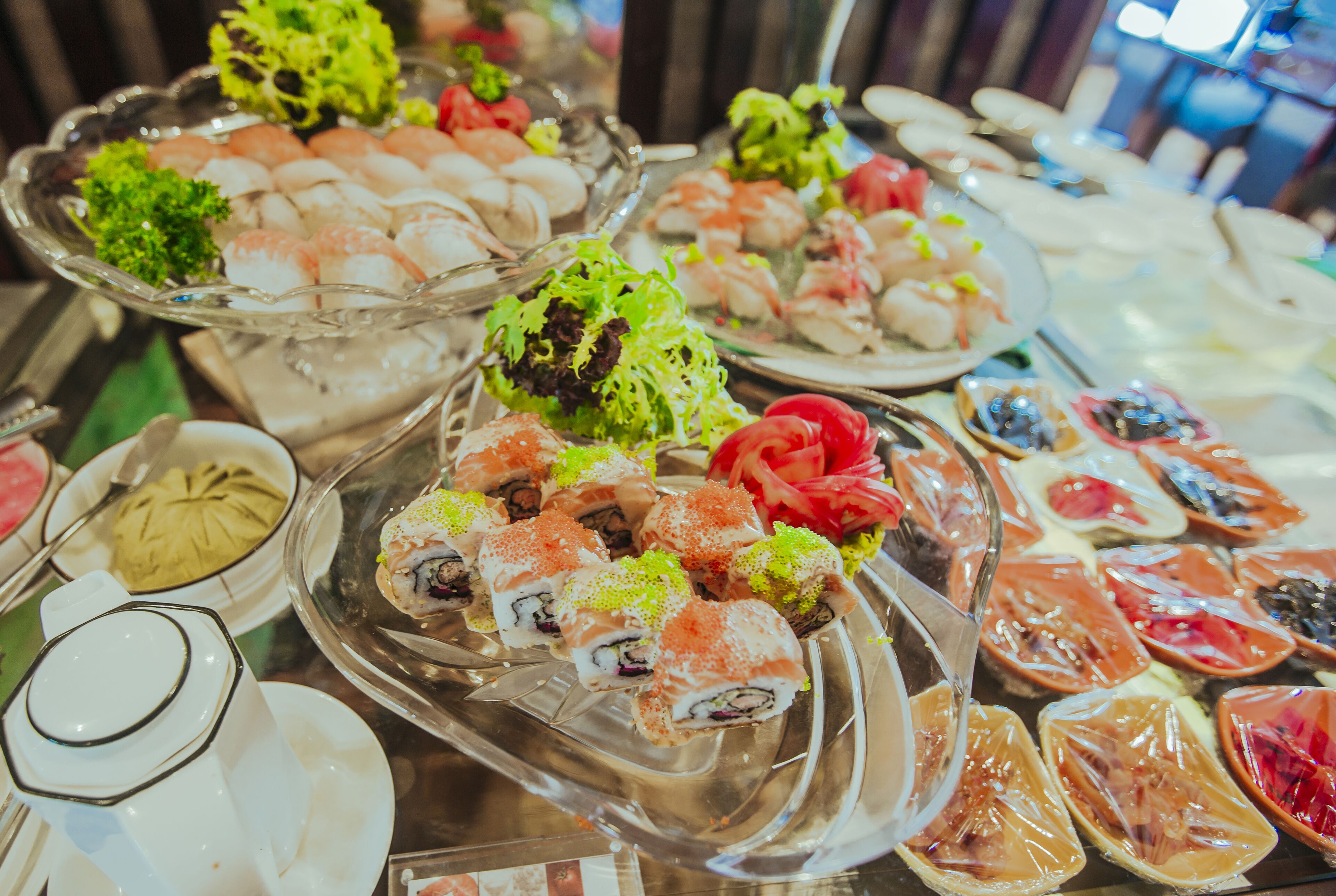 A buffet with various dishes including sushi, salads, and other appetizers.
