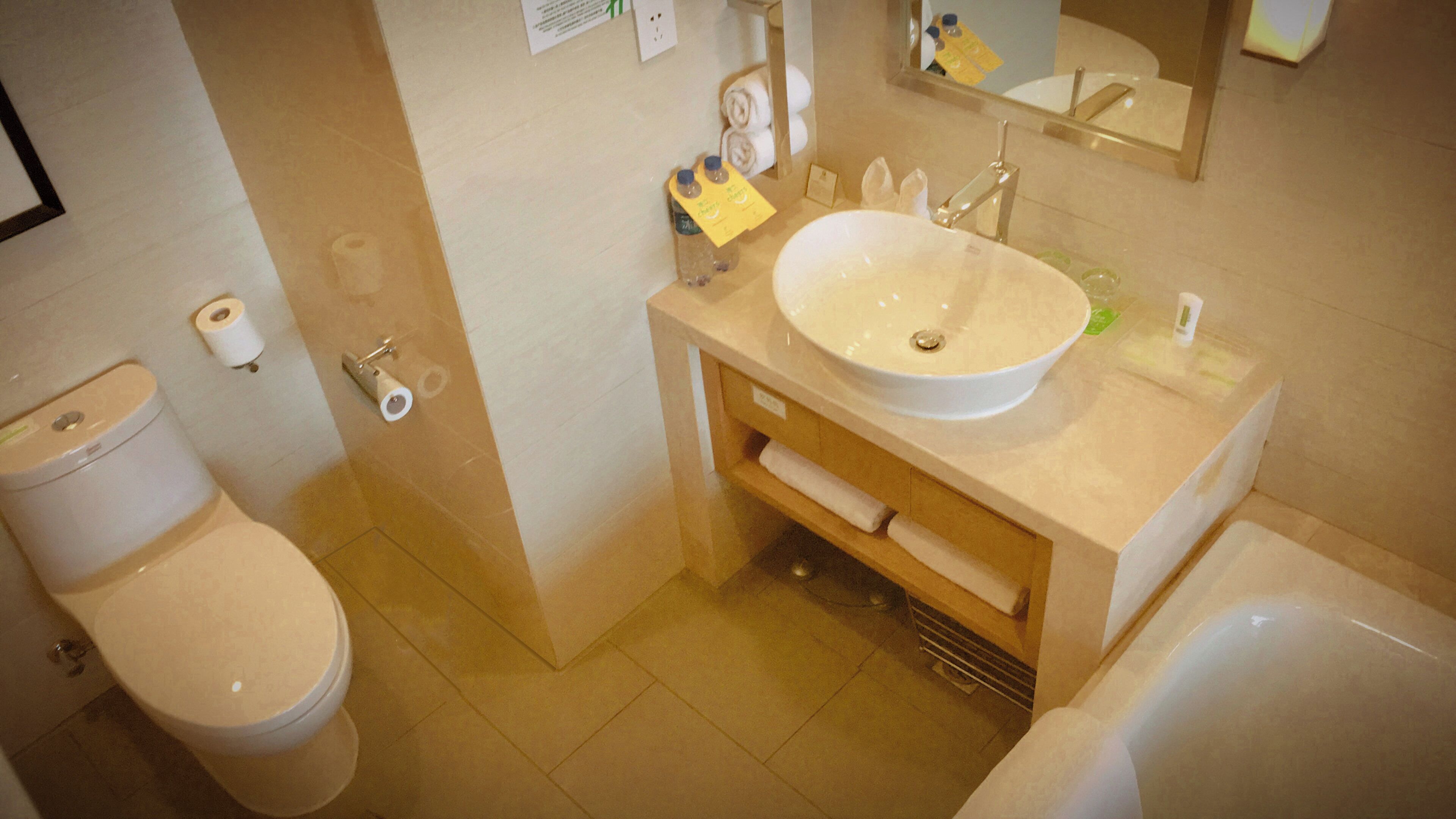 A bathroom with a toilet, sink, and bathtub.
