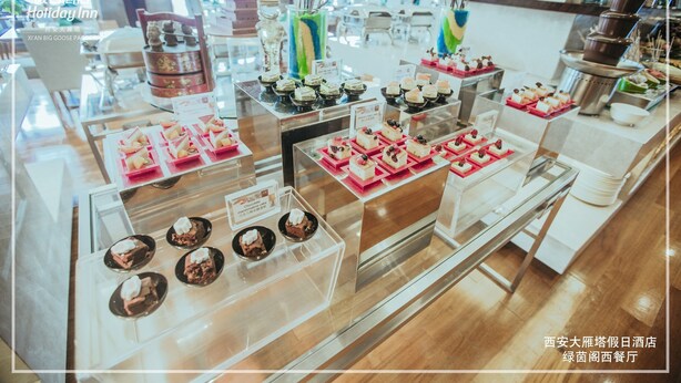 A buffet with various desserts and a traditional tea set. - Holiday Inn Xi'an Big Goose Pagoda by IHG (Xi'an)
