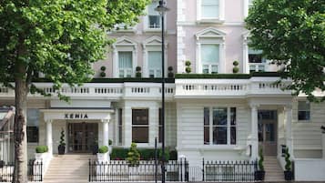 Stunning multi-story building with a traditional facade, featuring a prominent entrance and beautifully manicured surroundings.