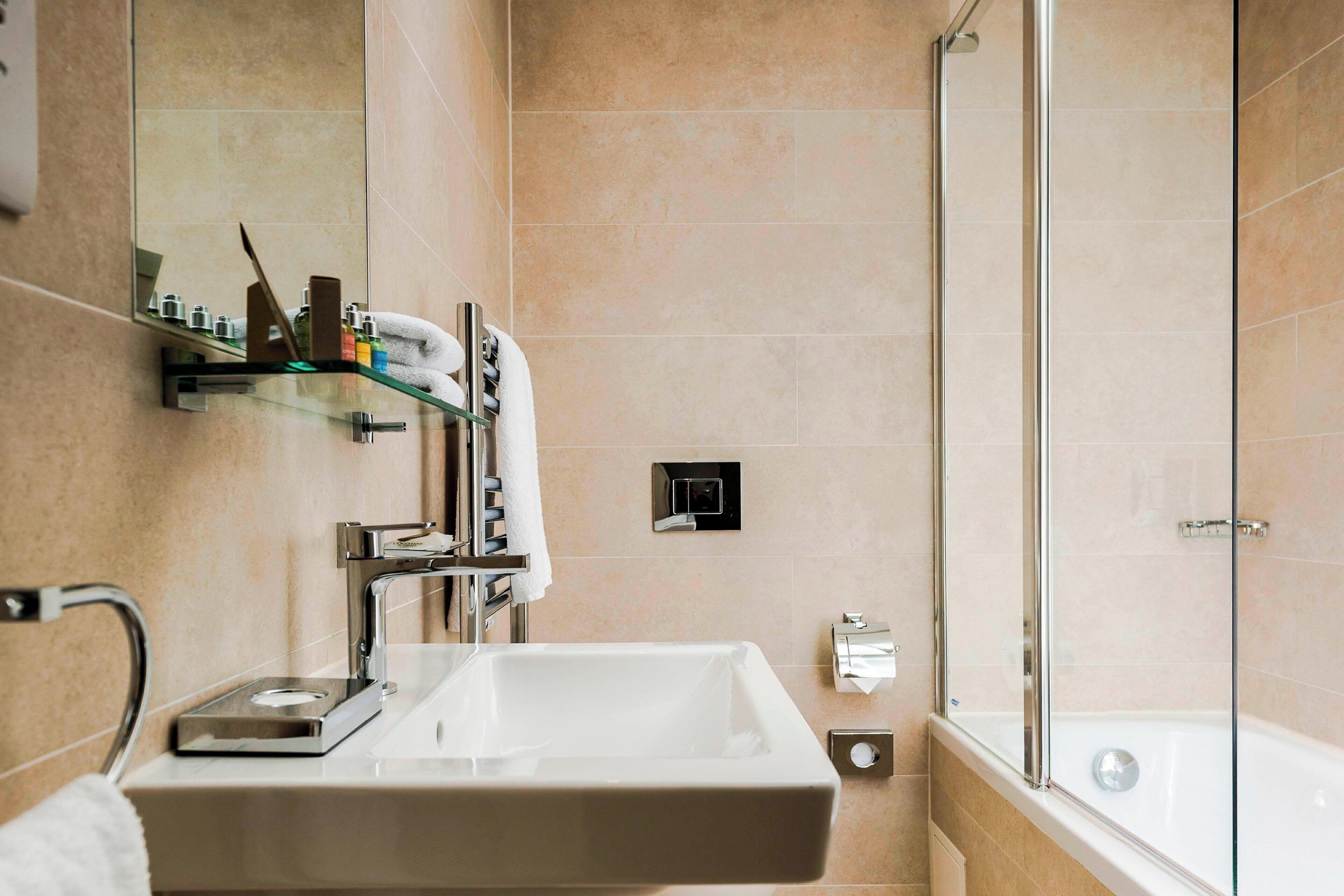 rainfall showerhead, designer toiletries, hair dryer, towels