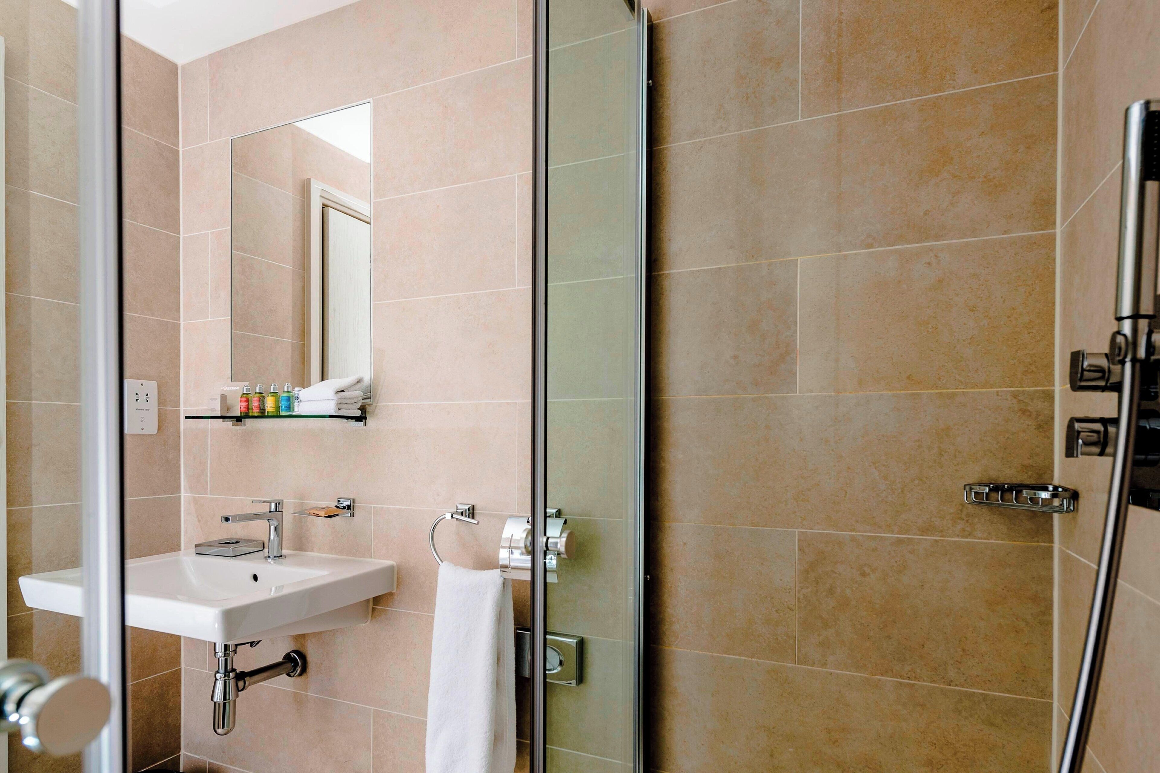 rainfall showerhead, designer toiletries, hair dryer, towels