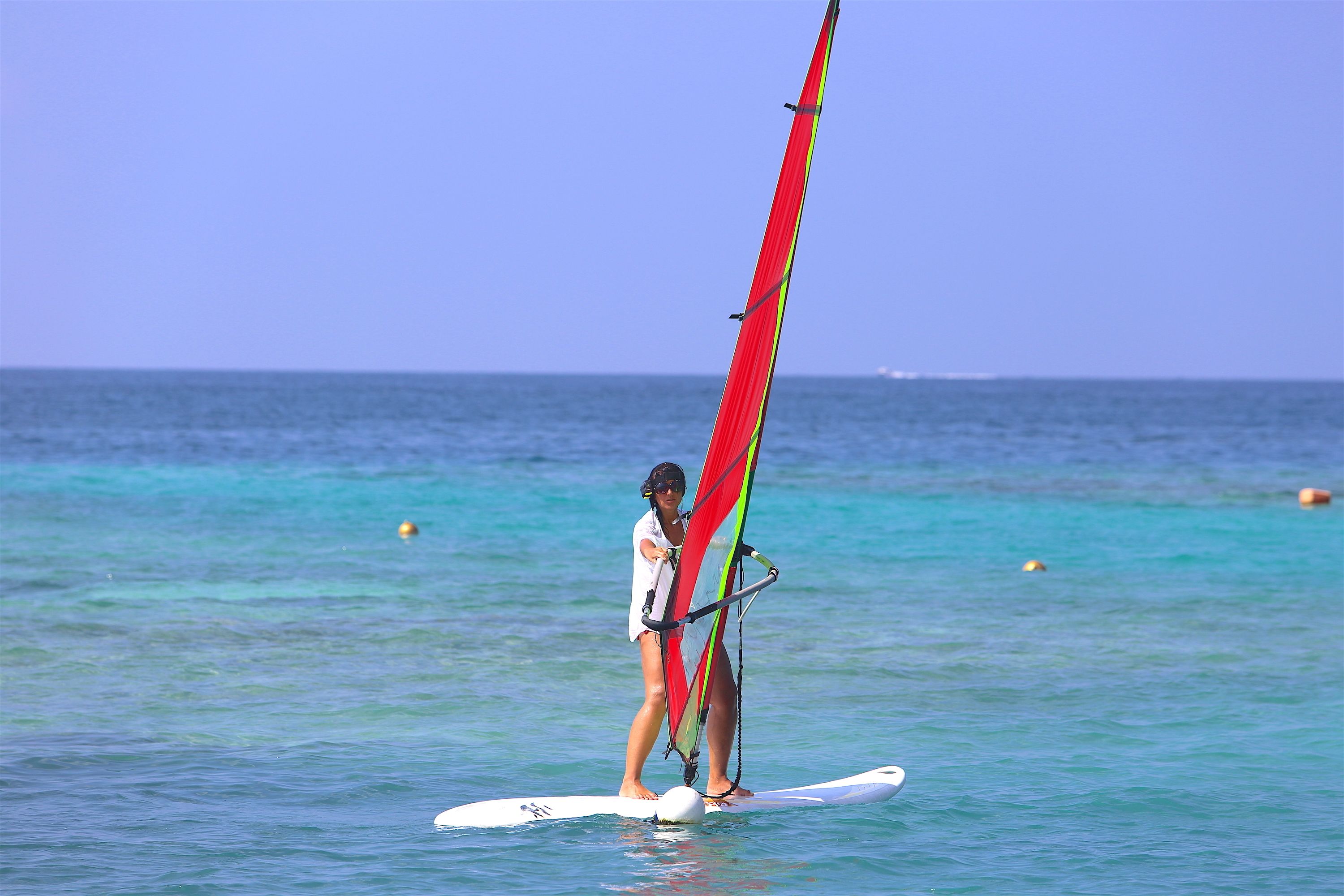 A person windsurfing on a clear day.