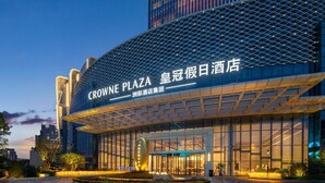 A modern hotel with a large glass facade, a prominent entrance, and a landscaped courtyard. - Crowne Plaza Huaihua by IHG (Huaihua)