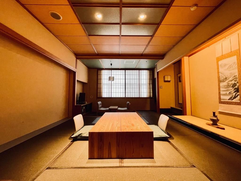 A traditional Japanese room with tatami flooring, a low wooden table, and shoji screens.