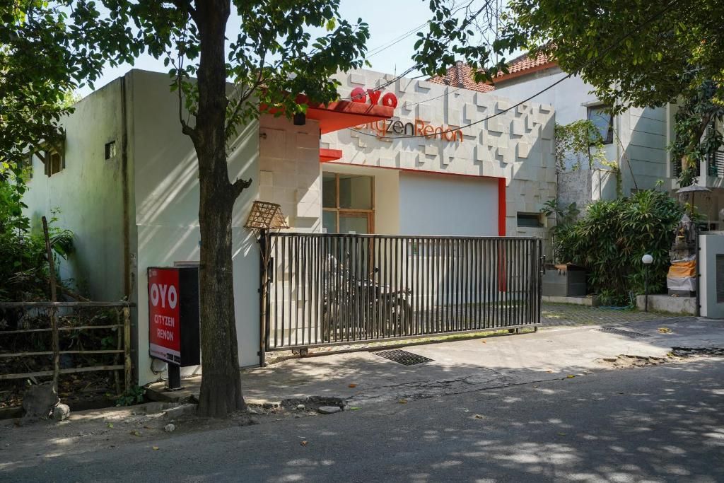 A gated entrance to a building with a sign that reads 'OYO CitizenRent.'