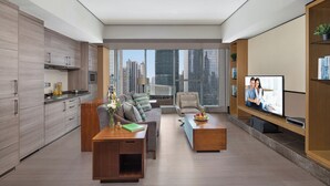 A modern living room with a sofa, coffee table, TV, and city view. - Ascott IFC Guangzhou (Guangzhou)