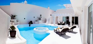 A rooftop pool area with a hot tub, lounge chairs, and potted plants. - Bahiazul Resort Fuerteventura (La Oliva)
