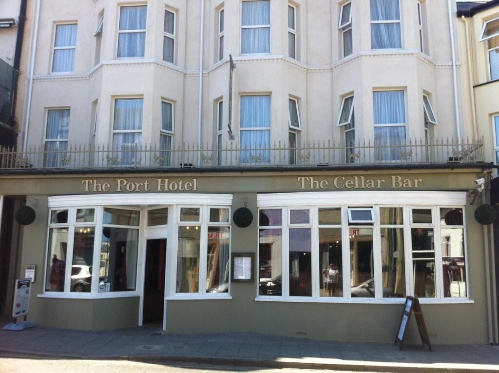 A building with two sections labeled "The Port Hotel" and "The Cellar Bar."